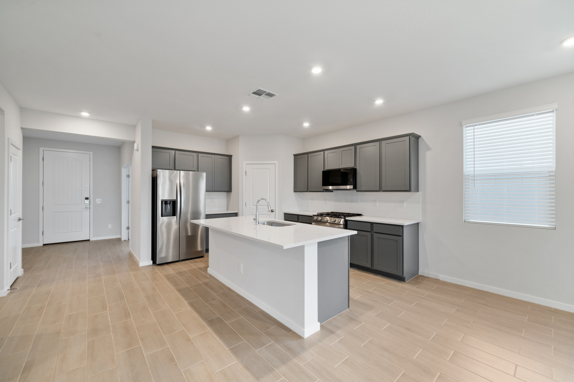 A kitchen with white cabinets.