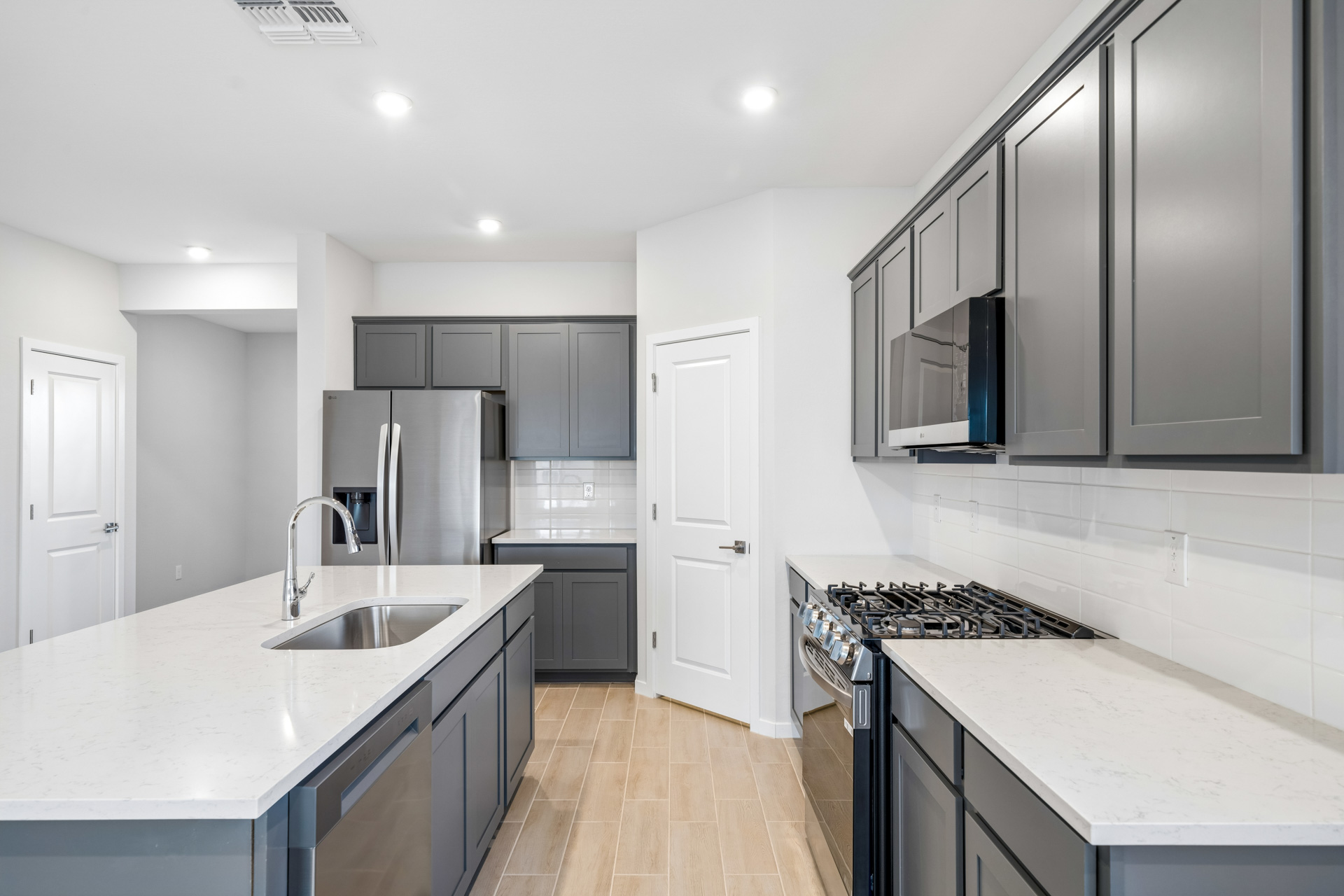 A kitchen with black cabinets.