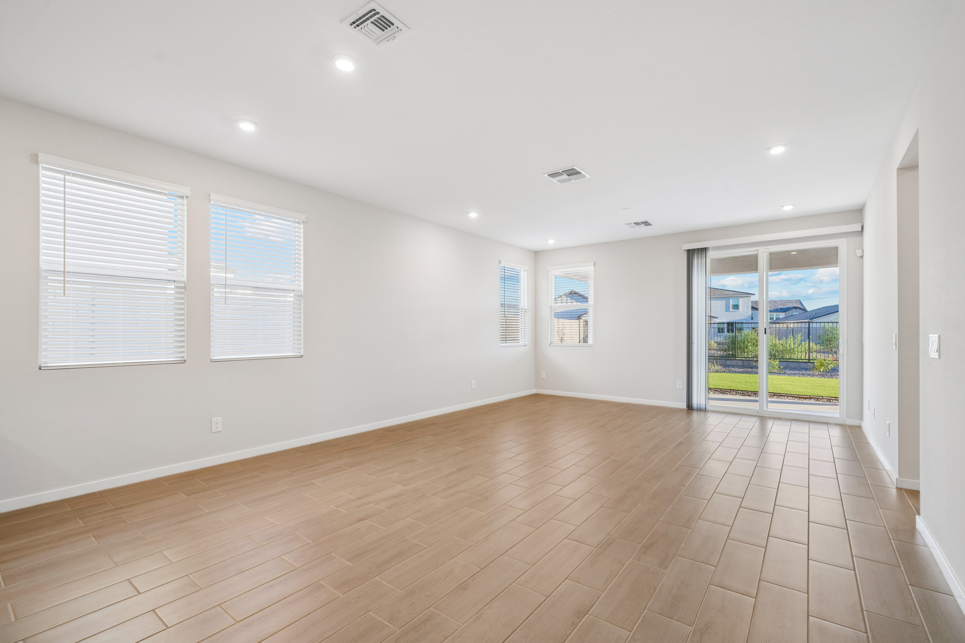 A room with a wood floor and windows.