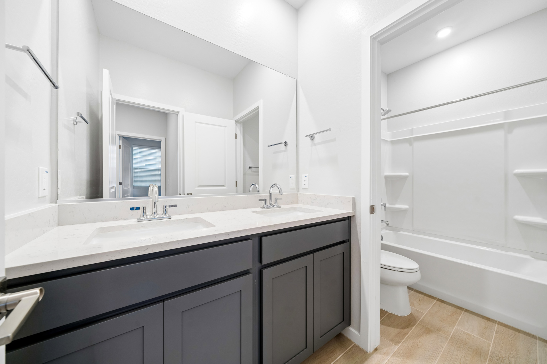 A bathroom with a tub sink and toilet.