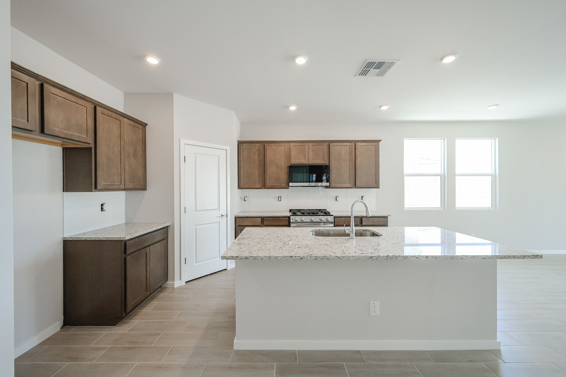 A kitchen with wooden cabinets.