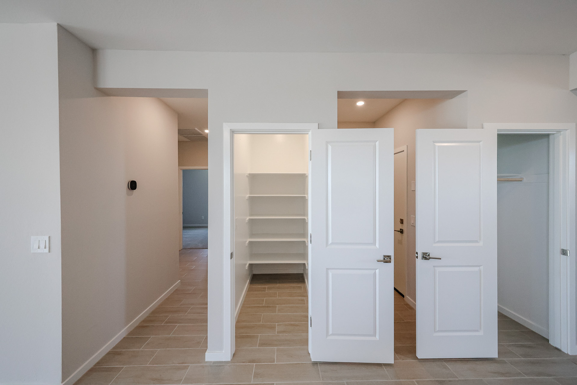 A hallway with white doors.