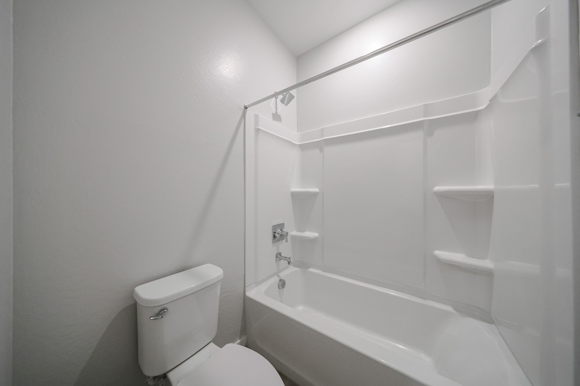A bathroom with a tub toilet and sink.