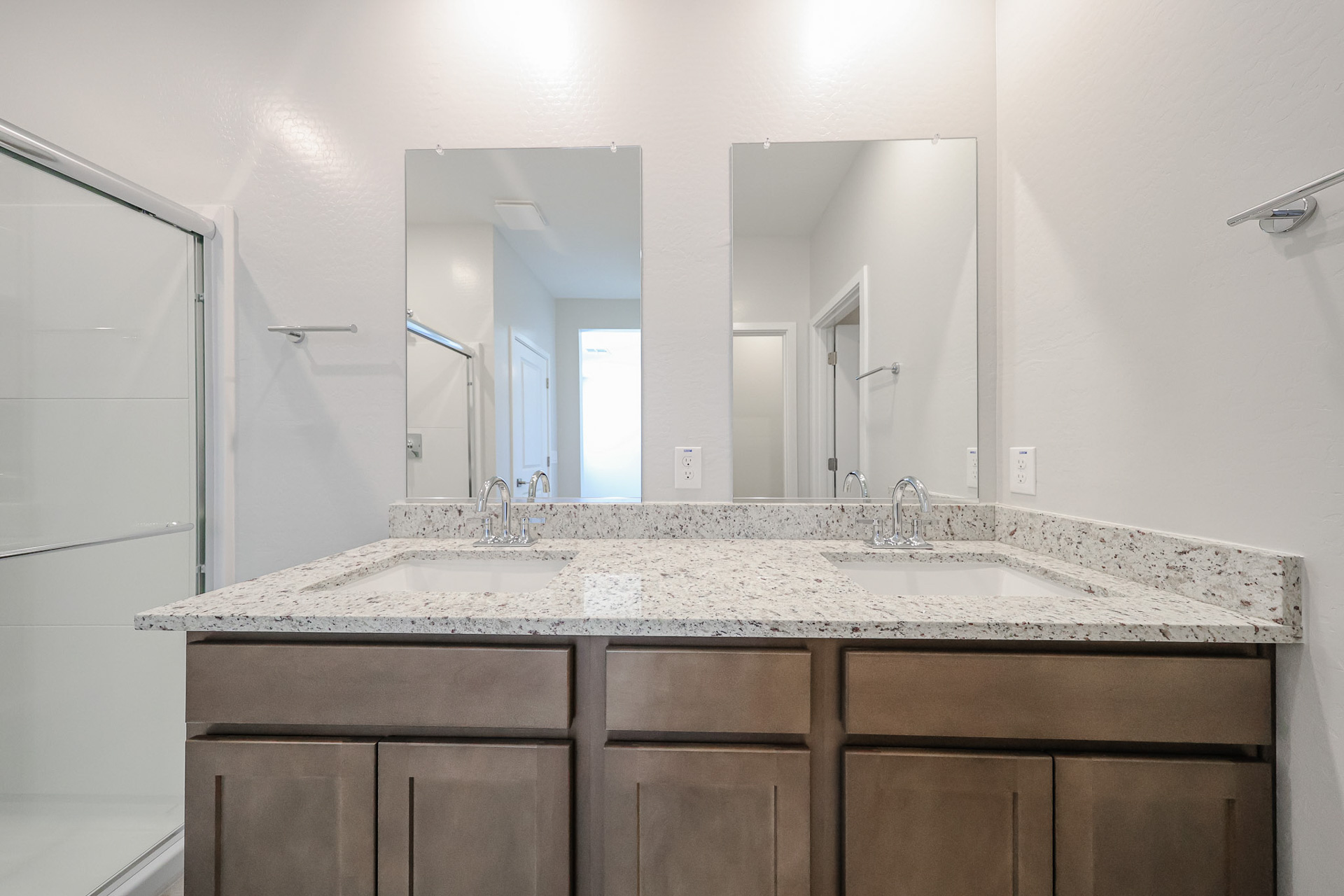 A bathroom with sinks and mirrors.