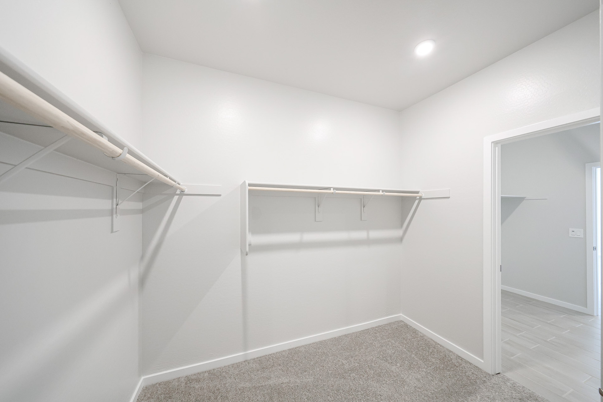 A white room with a glass door.