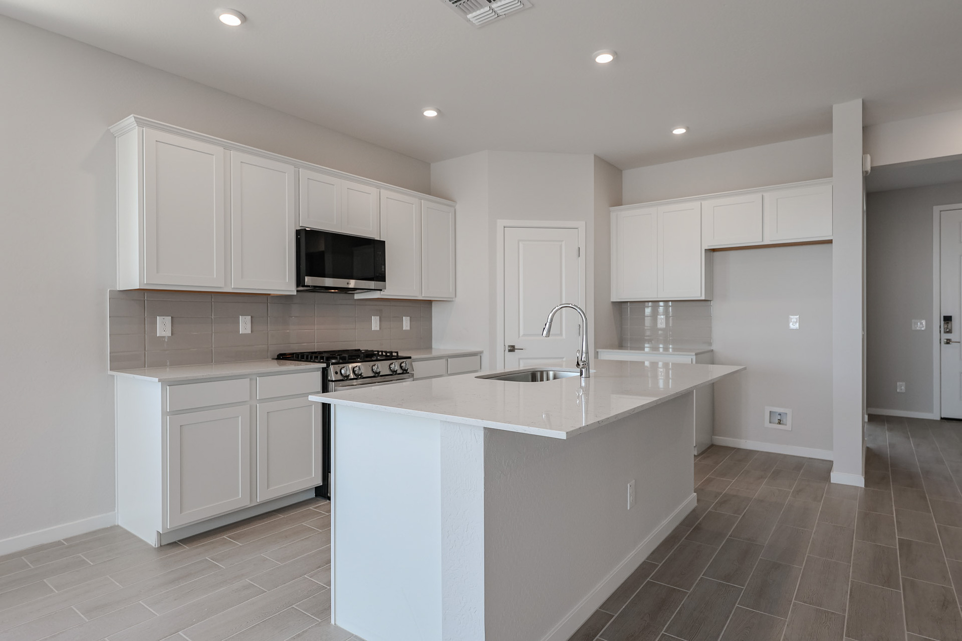 A kitchen with white cabinets.