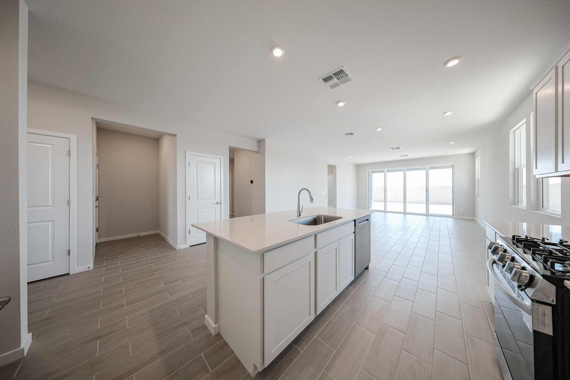 A kitchen with white cabinets.