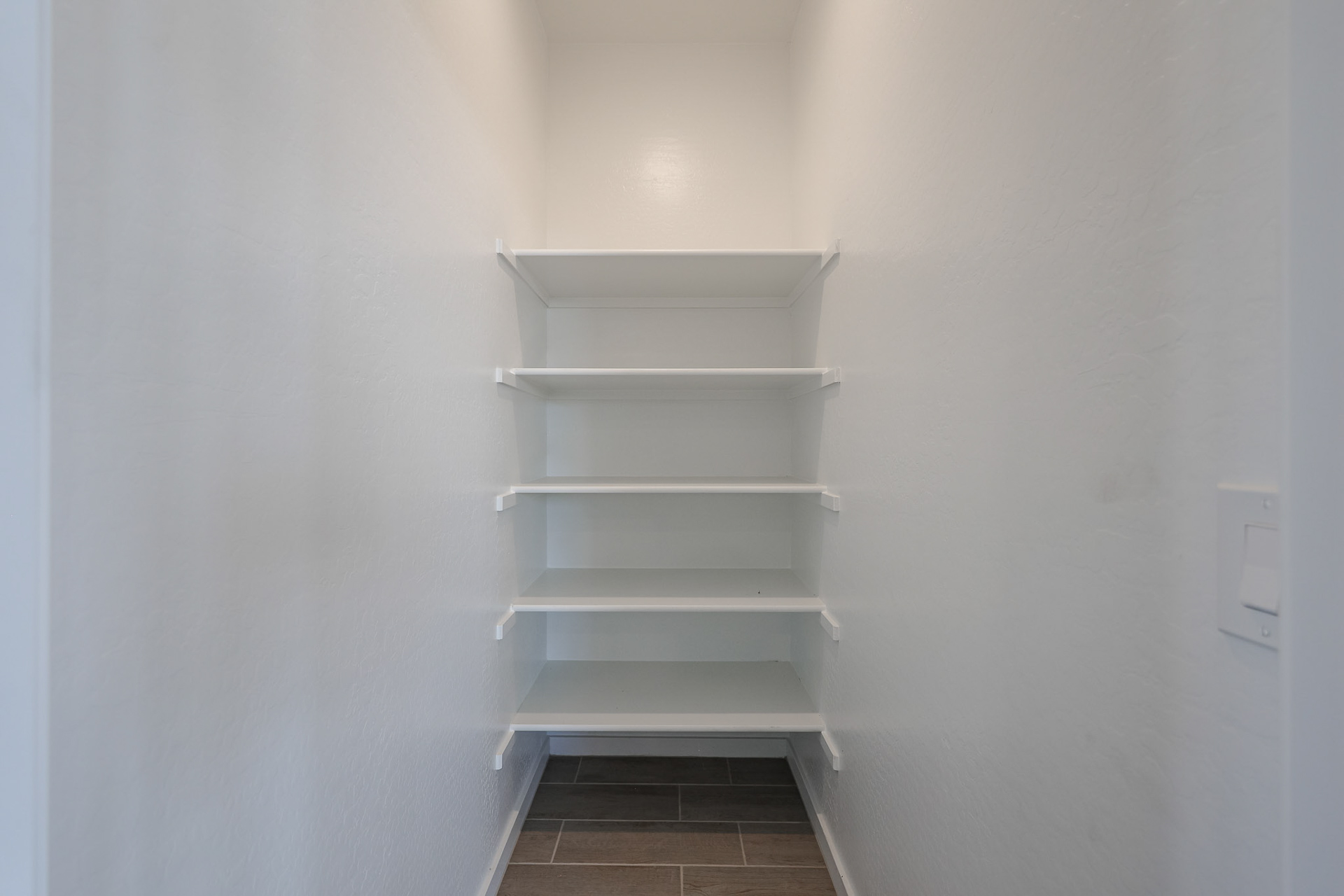 A white shelf in a room.