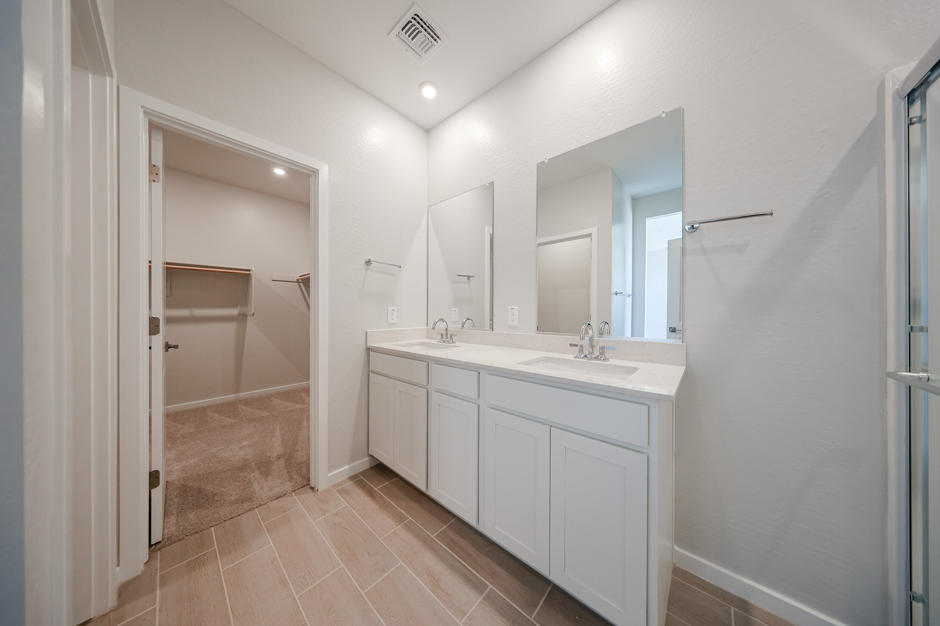 A bathroom with a sink and a shower.