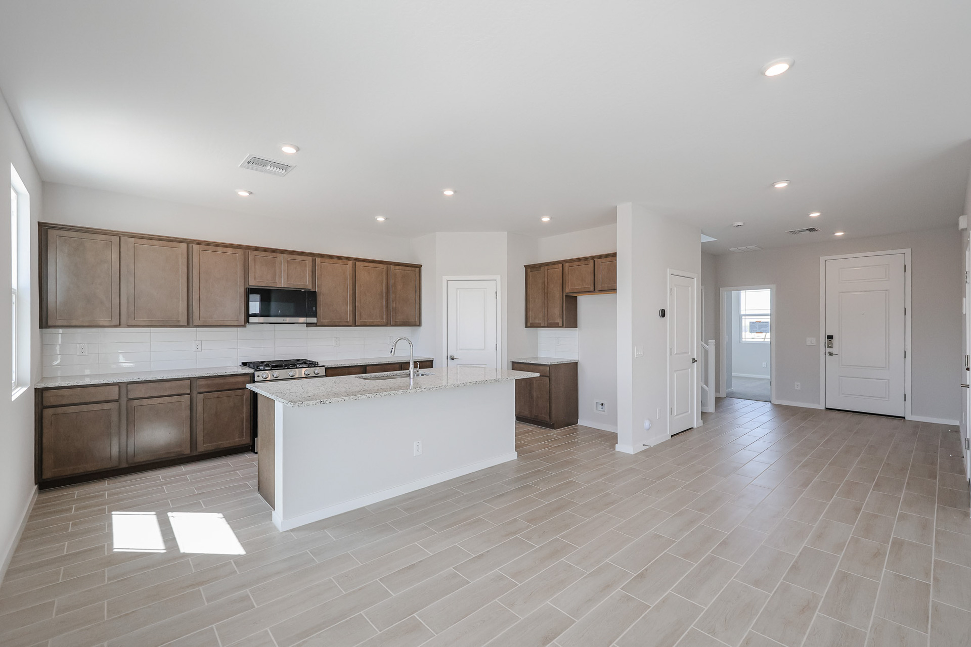 A large kitchen with wooden cabinets.