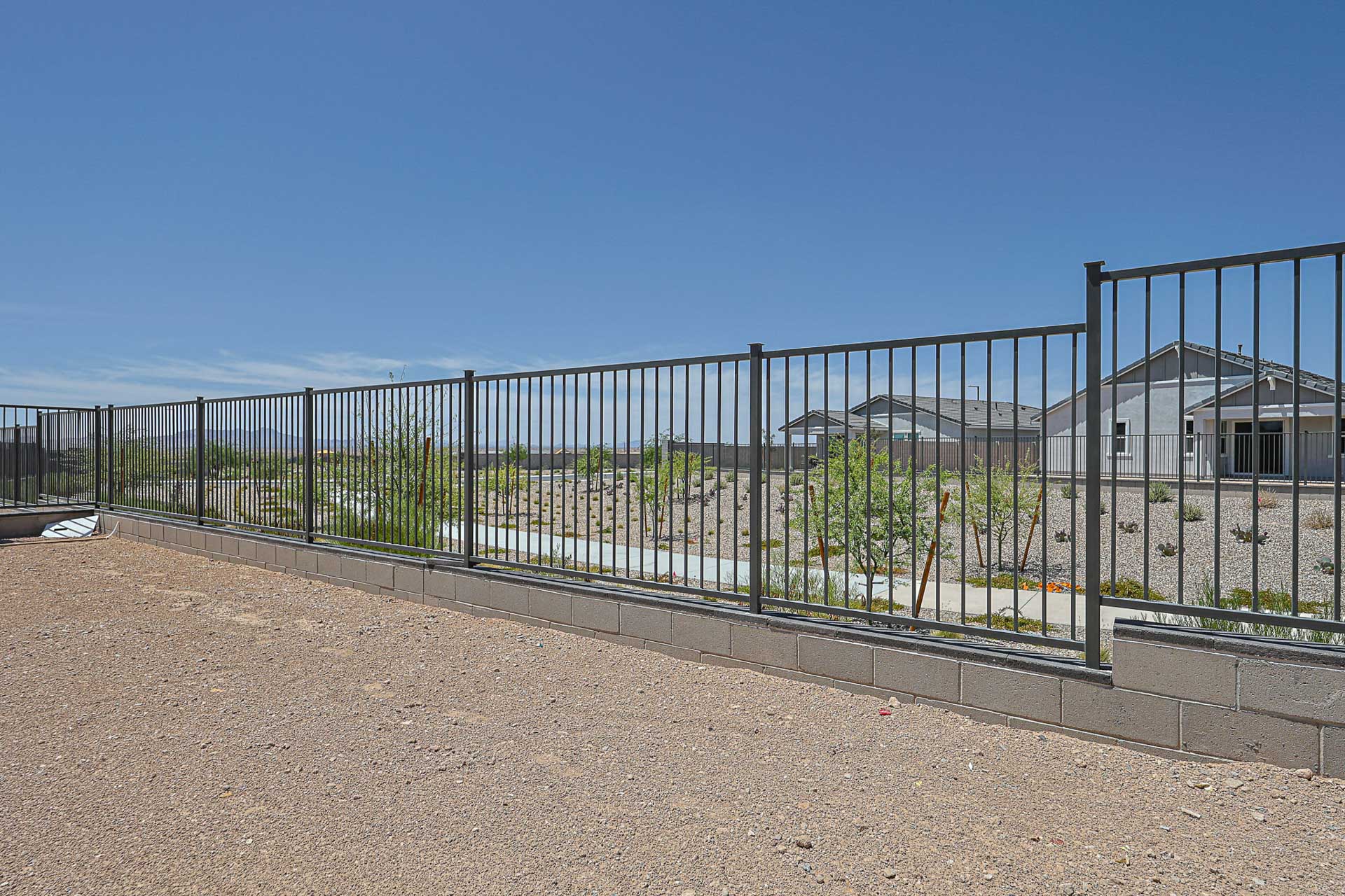 A fenced off area with a building in the background.
