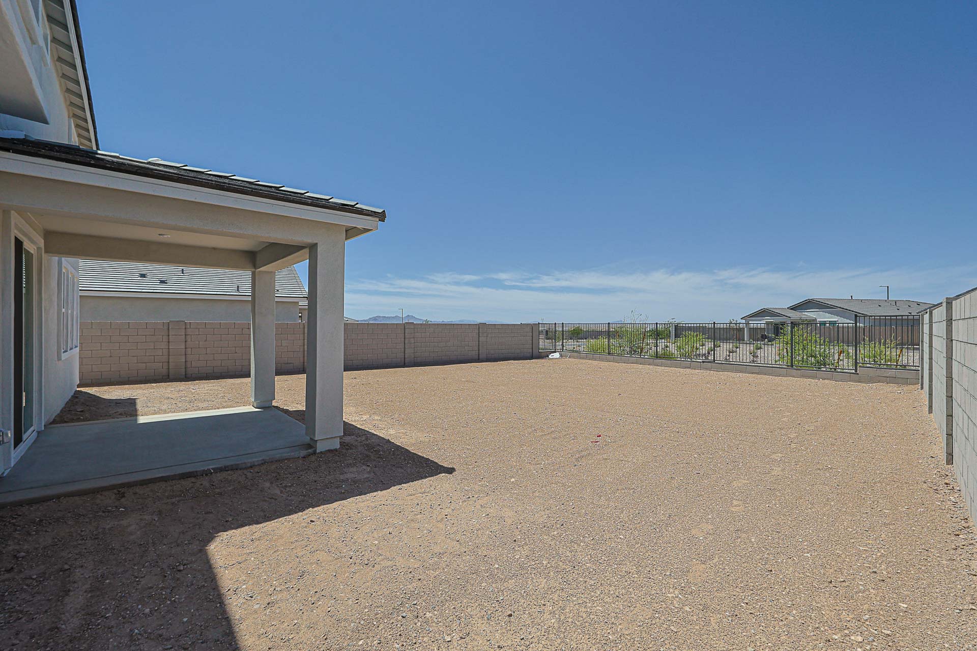 A building with a fence and a dirt road.