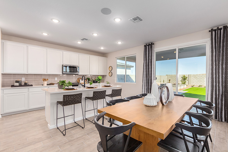 A kitchen with a dining table.