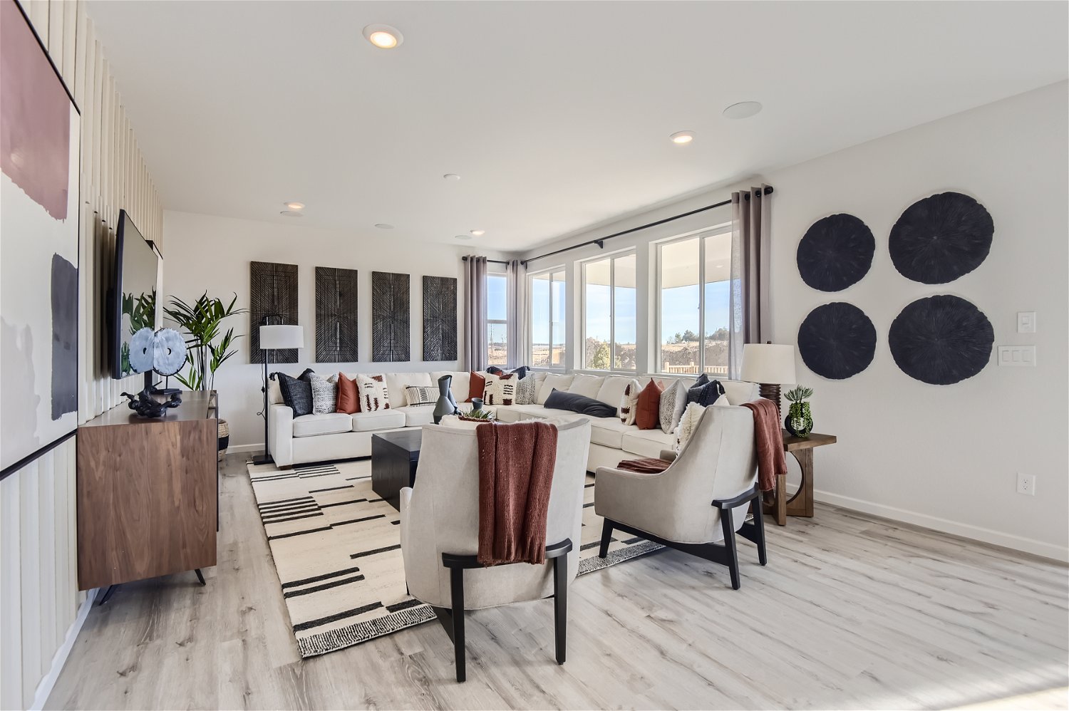A living room with a large white couch and a table.