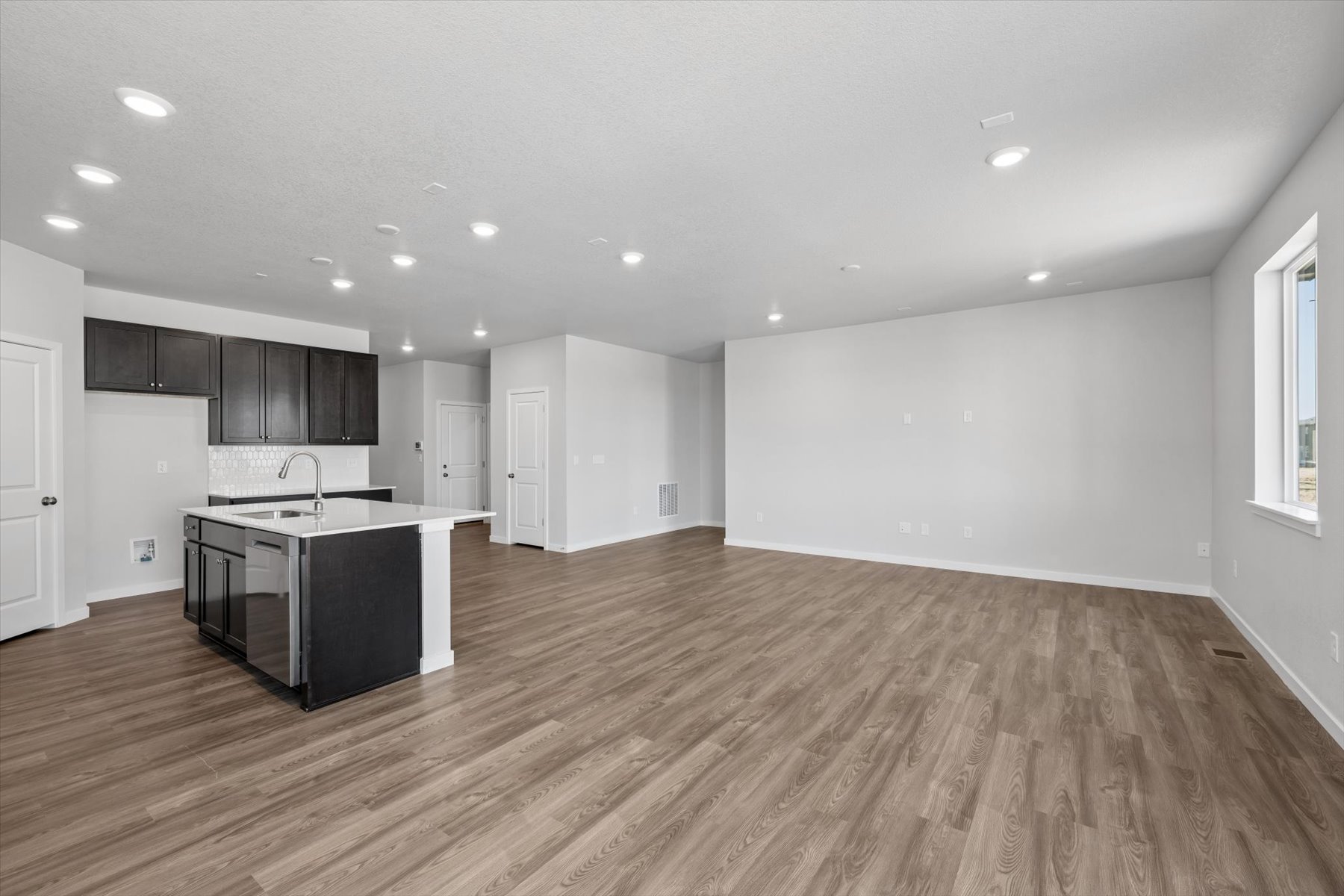 A large kitchen with black cabinets.