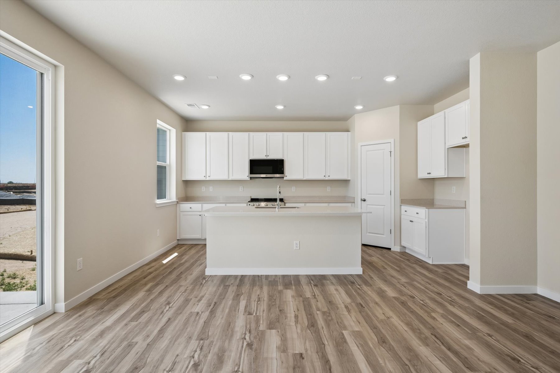 A kitchen with white cabinets.