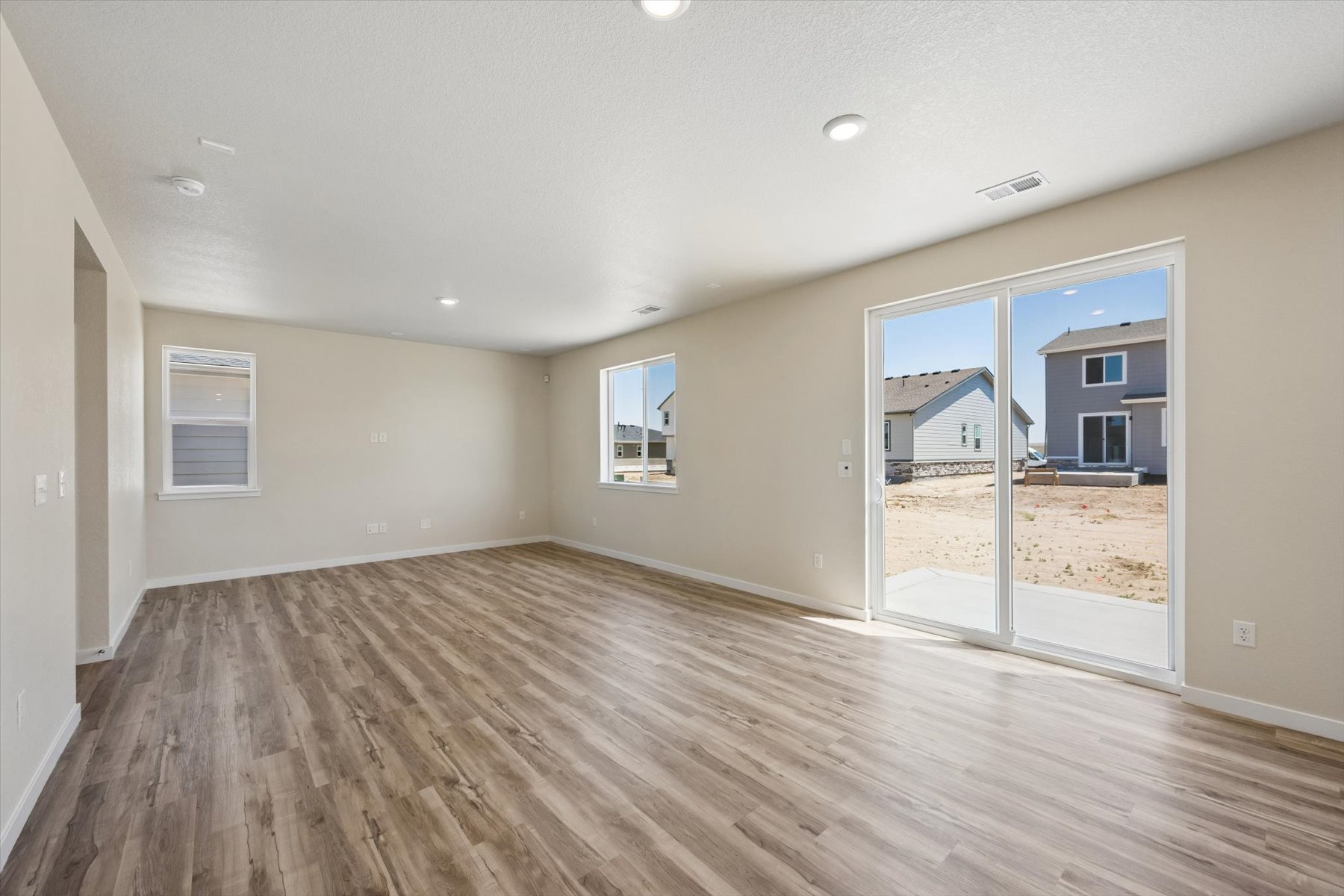 A room with a wood floor and a glass door.