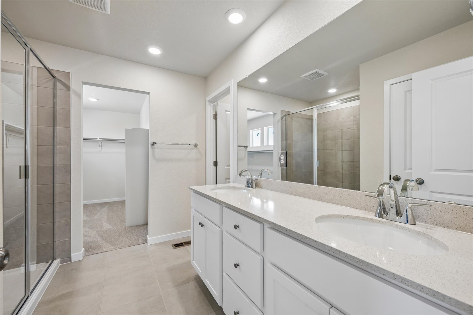 A bathroom with a large mirror.