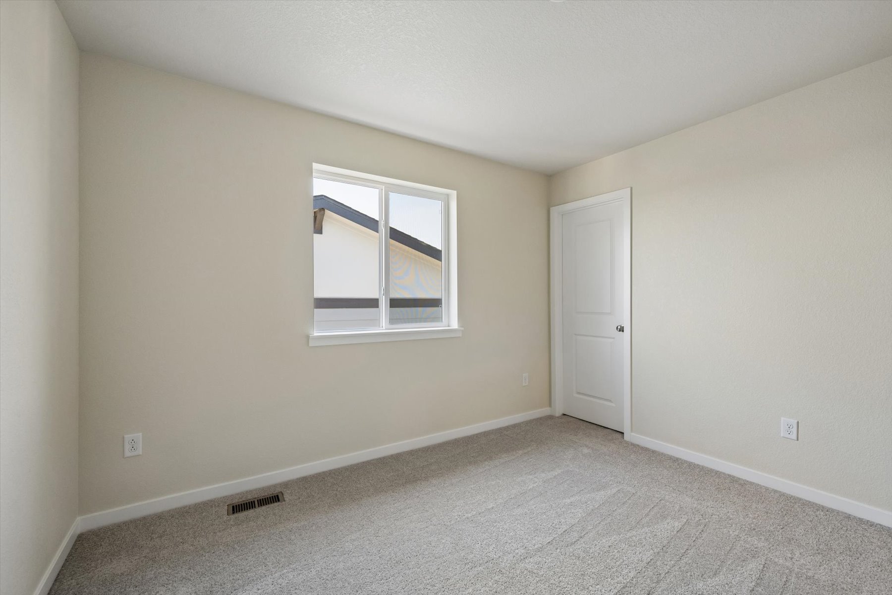 A room with a window and a door.