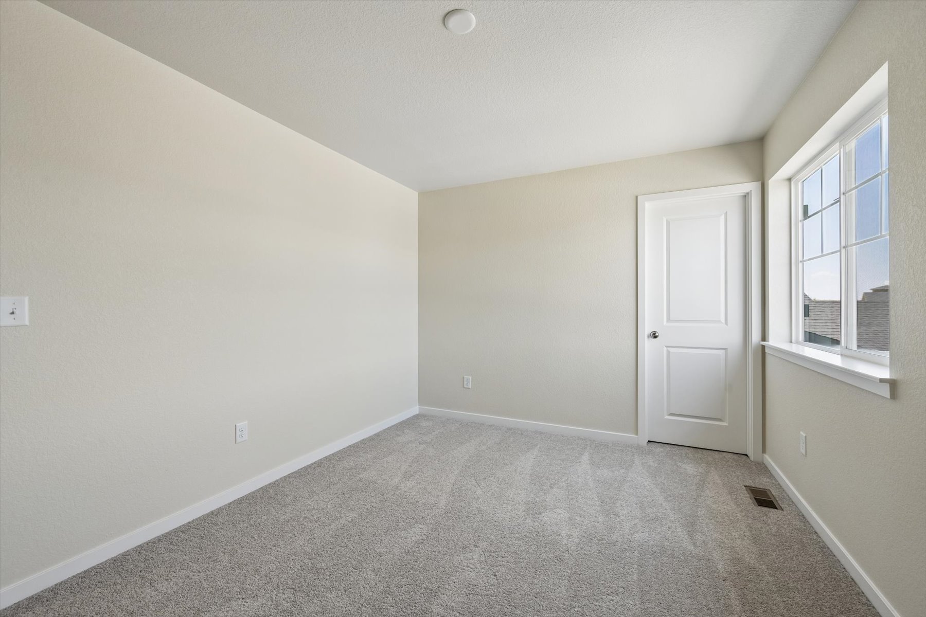 A room with a door and windows.