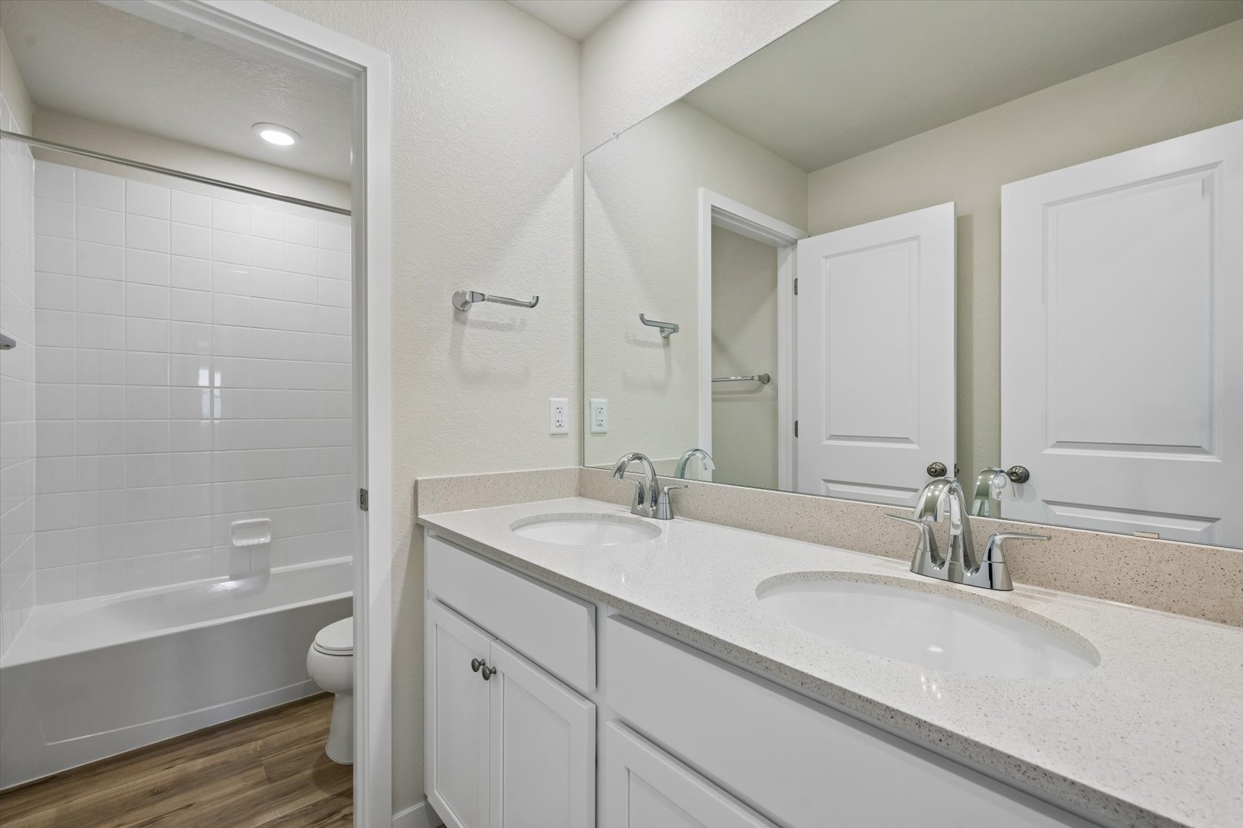 A bathroom with a tub sink and toilet.