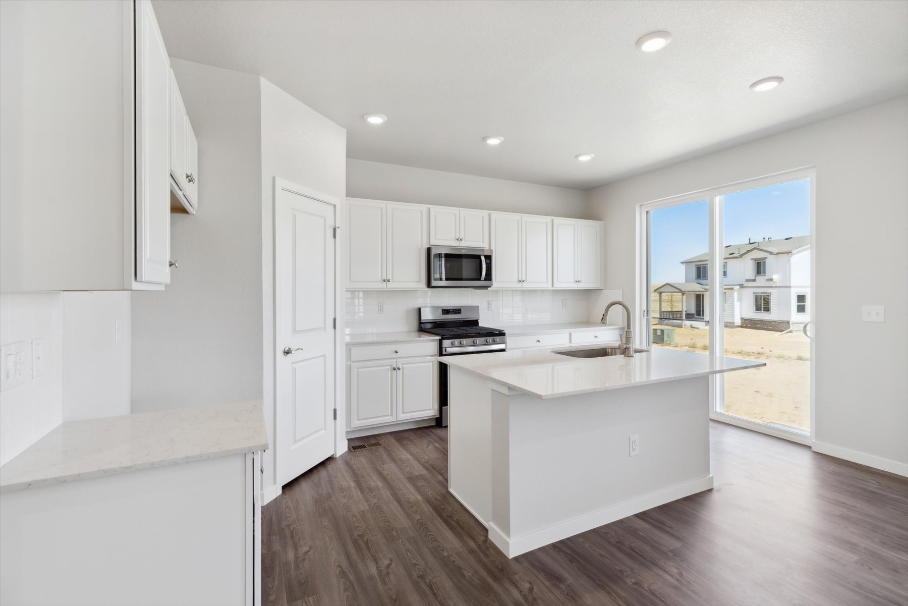A kitchen with white cabinets.