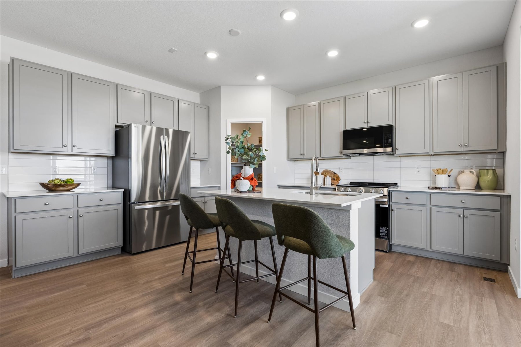 A kitchen with white cabinets.