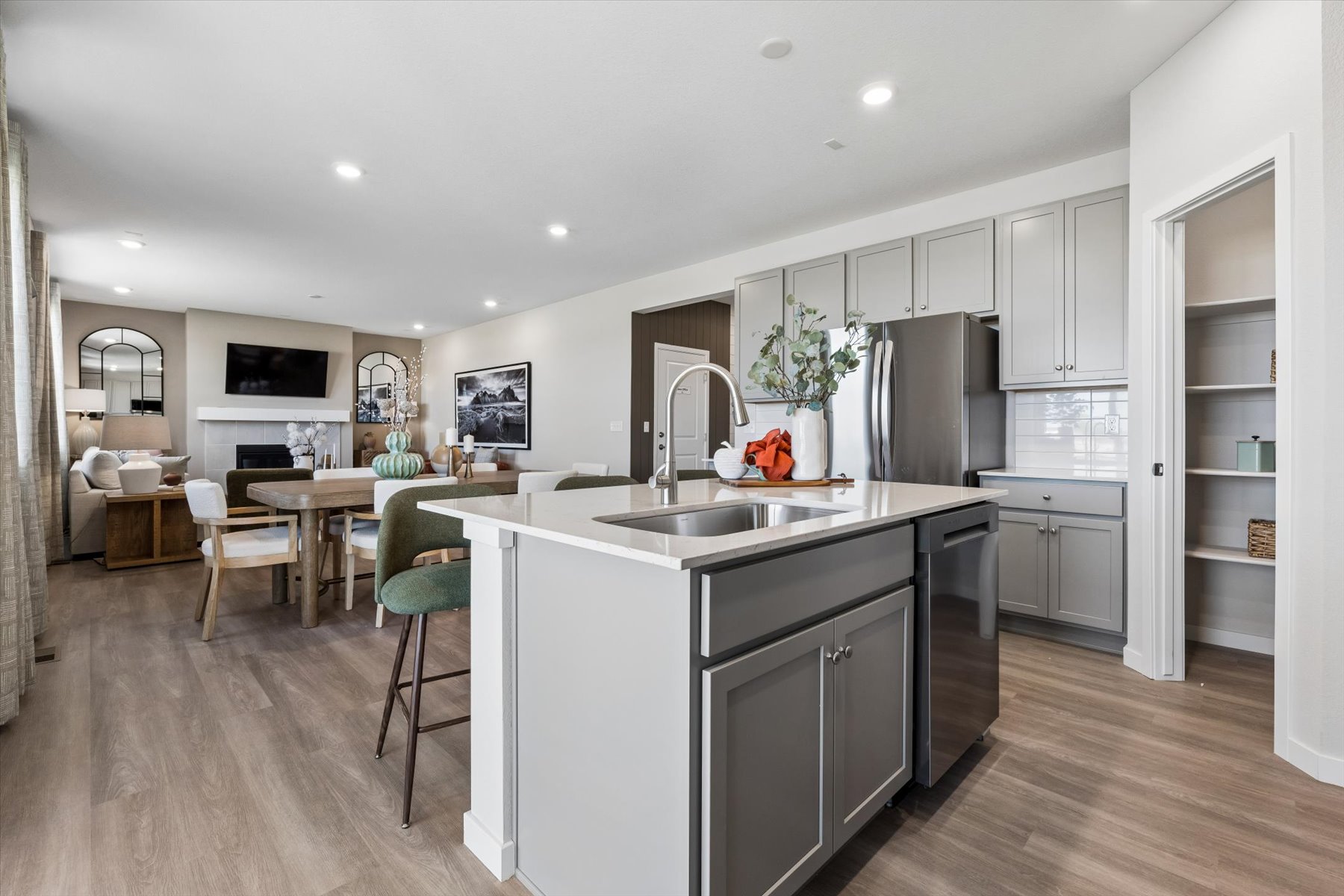 A kitchen with white cabinets.