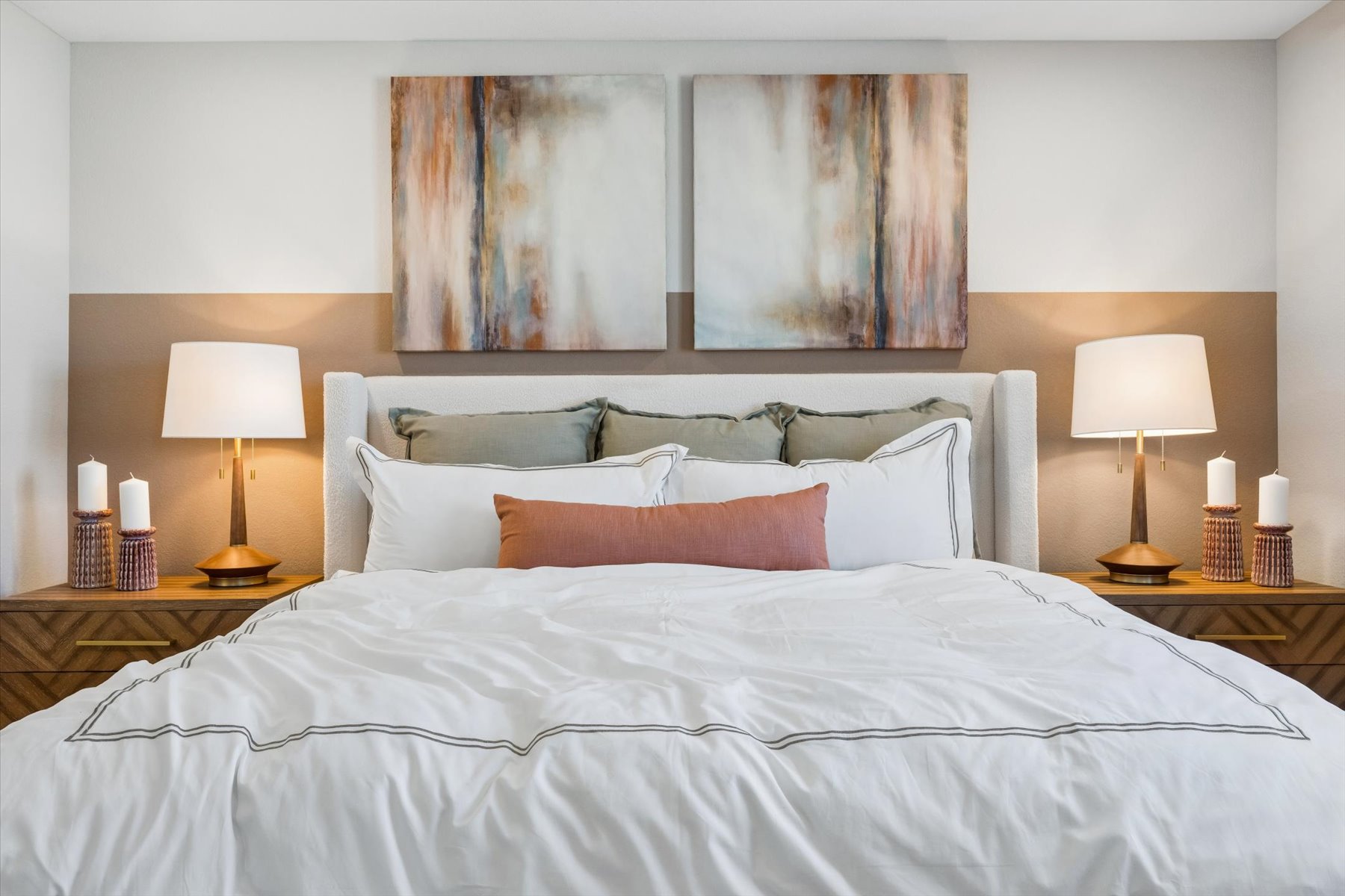 A bed with white sheets.