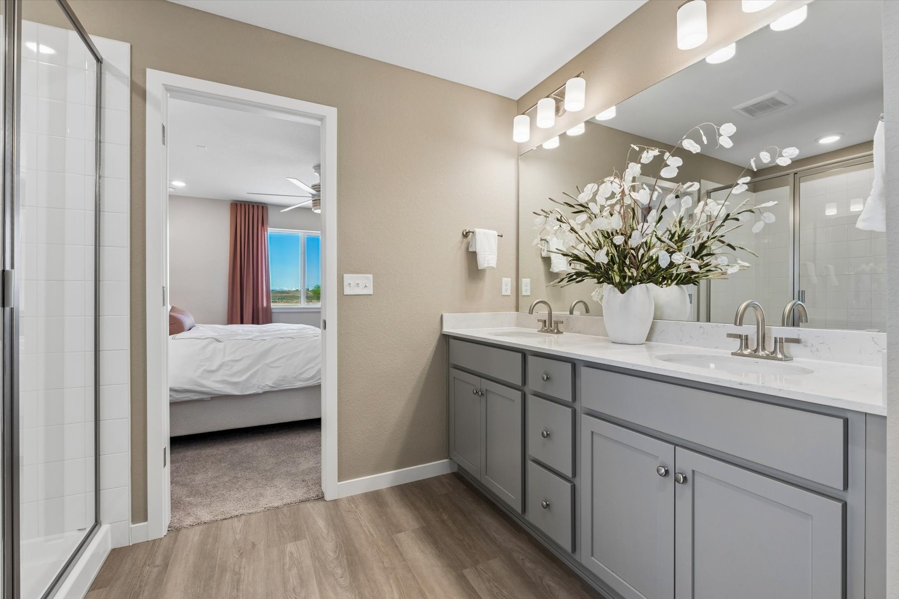 A bathroom with a large mirror.