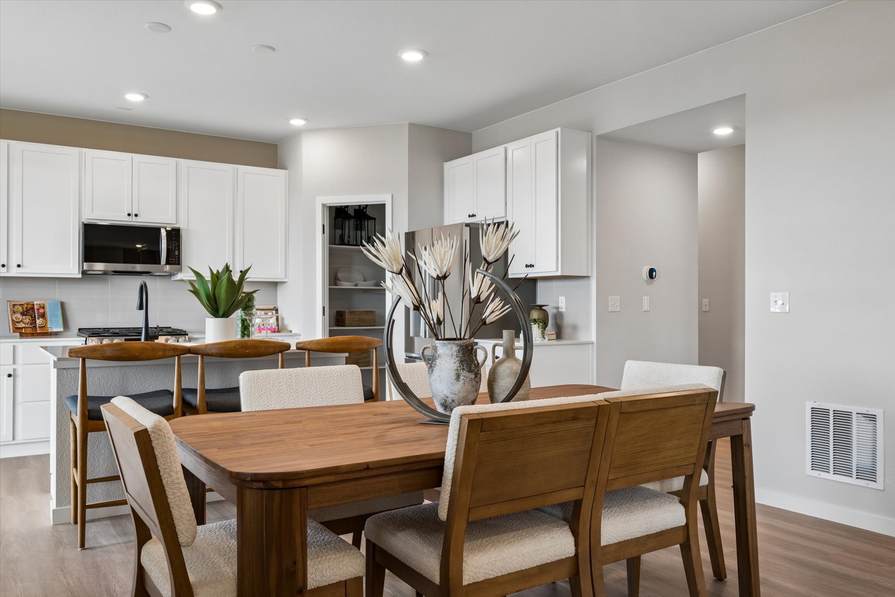 A kitchen with white cabinets.