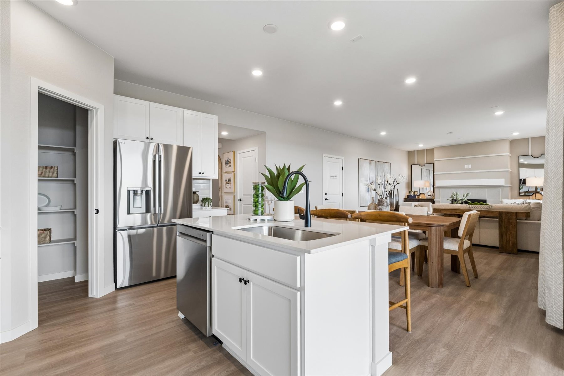 A kitchen with white cabinets.