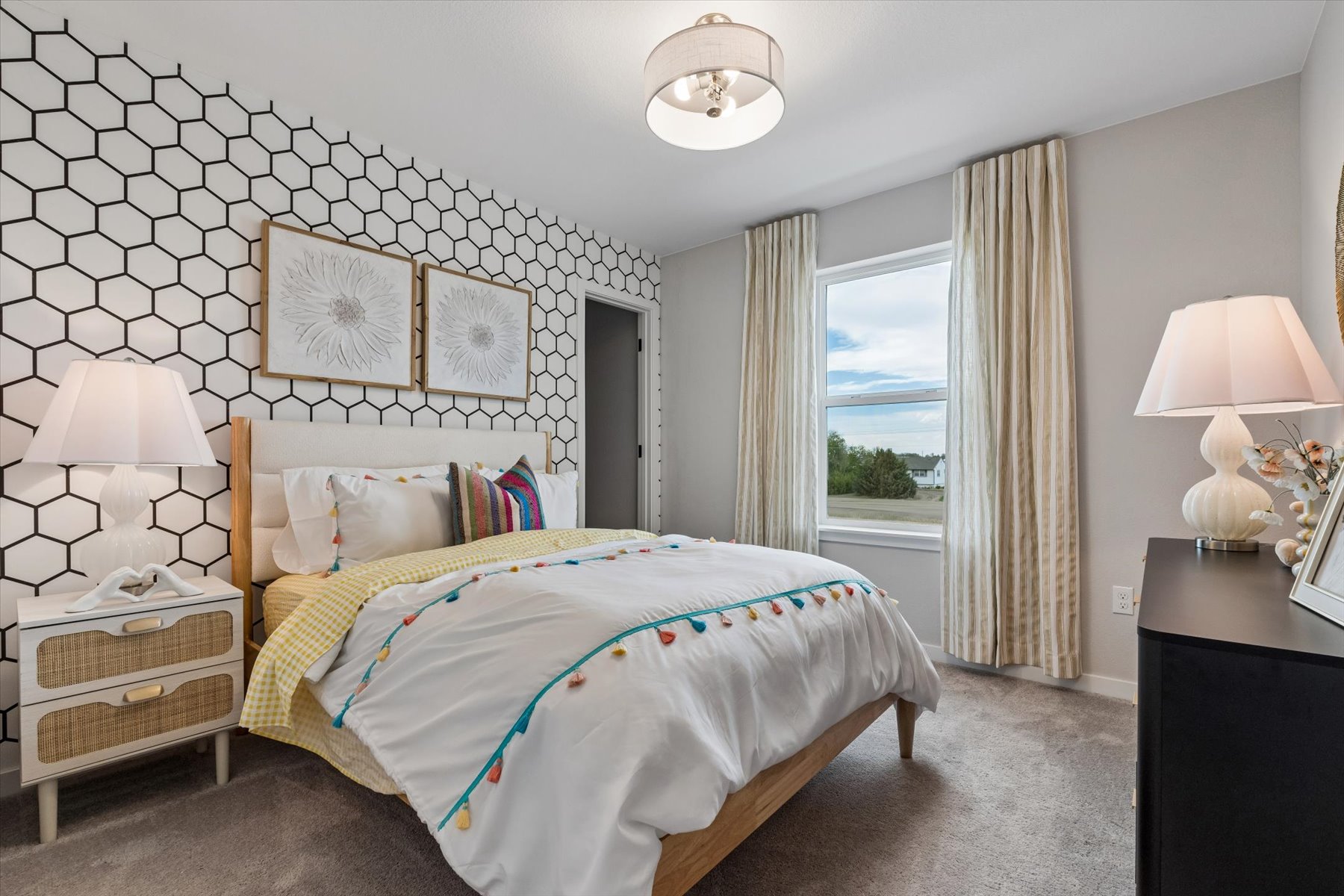 A bedroom with a bed and a window.