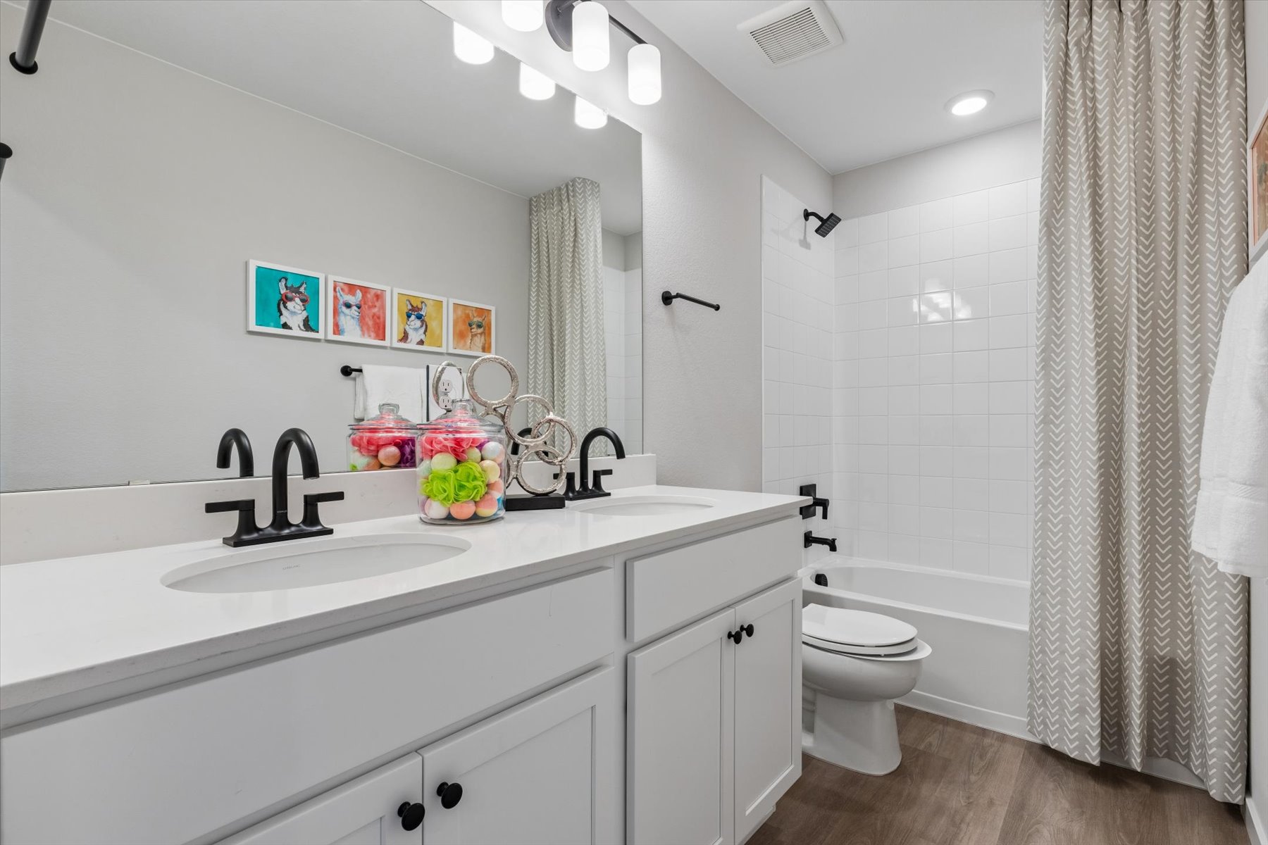 A bathroom with a sink toilet and shower.