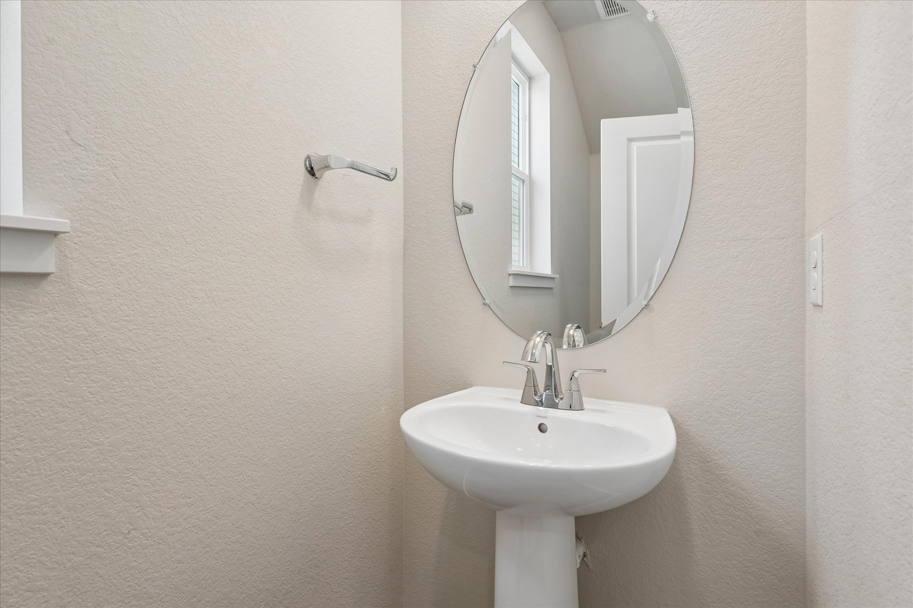 A bathroom with a mirror and sink.