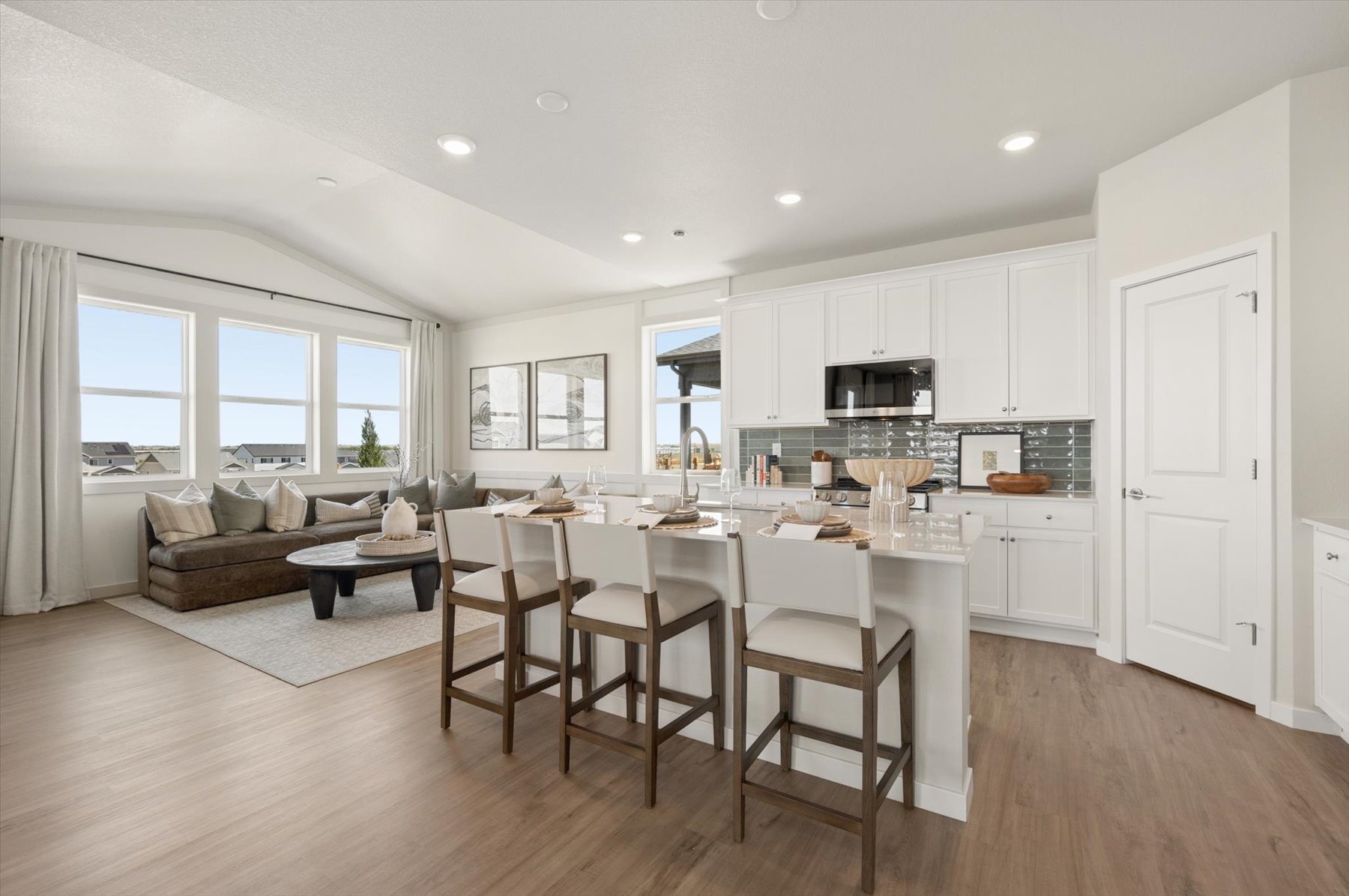 A large kitchen with a dining table.