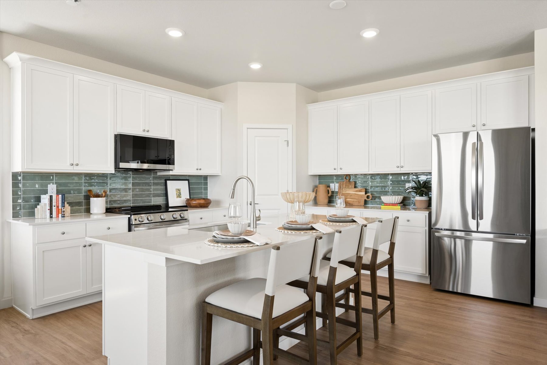 A kitchen with white cabinets.
