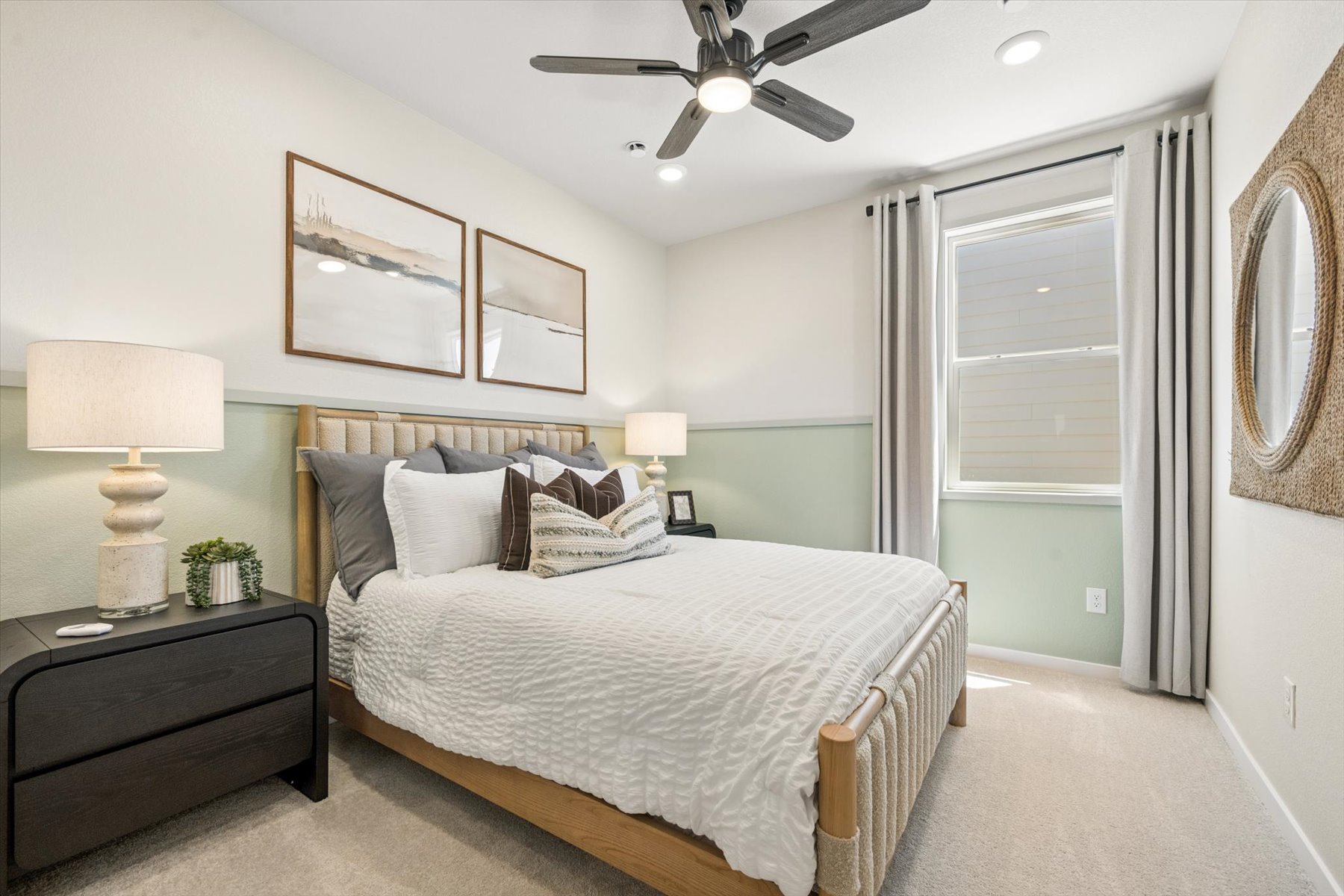 A bedroom with a bed and a fan.