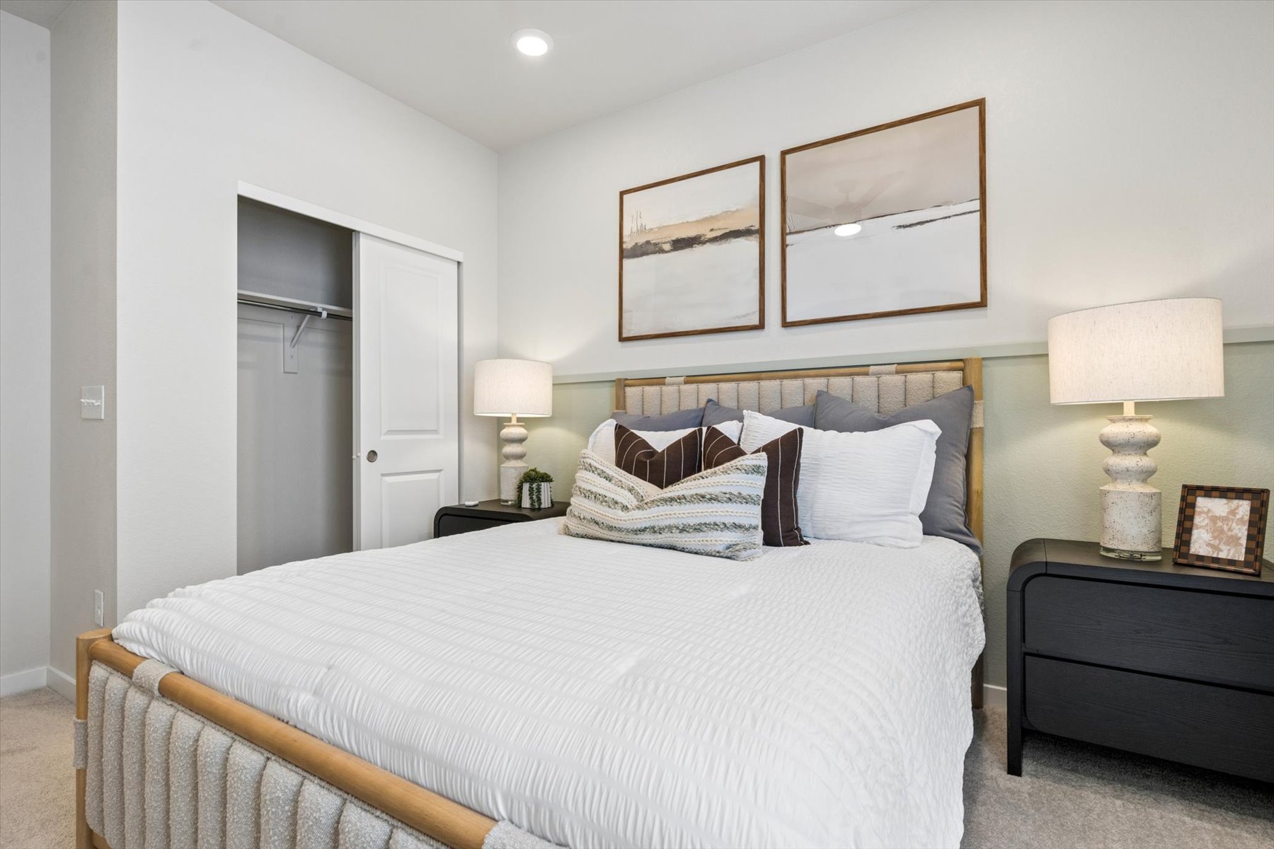 A bed with a white bed spread.