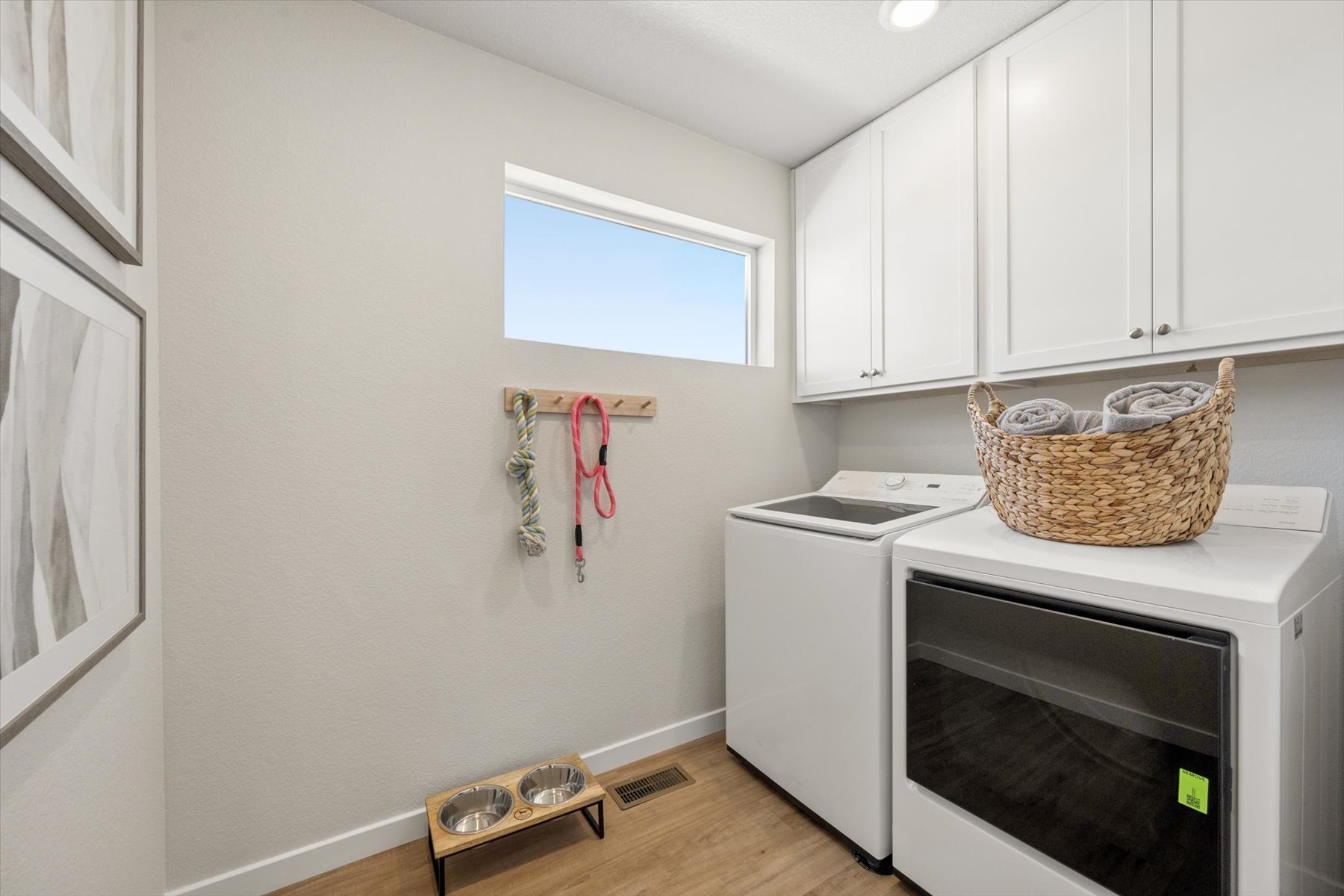 A kitchen with white cabinets.