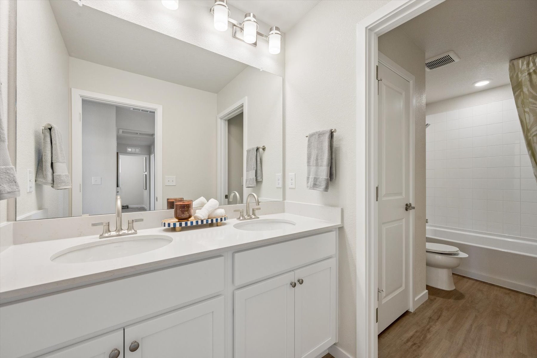 A bathroom with a large mirror.