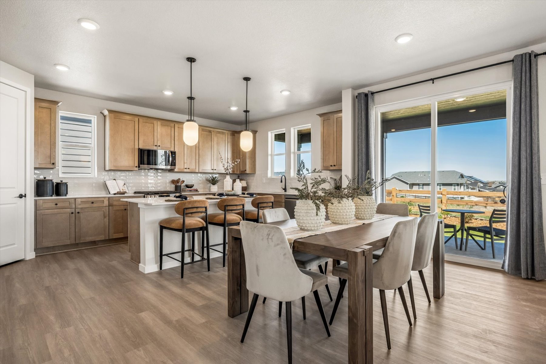 A kitchen with a dining table and chairs.