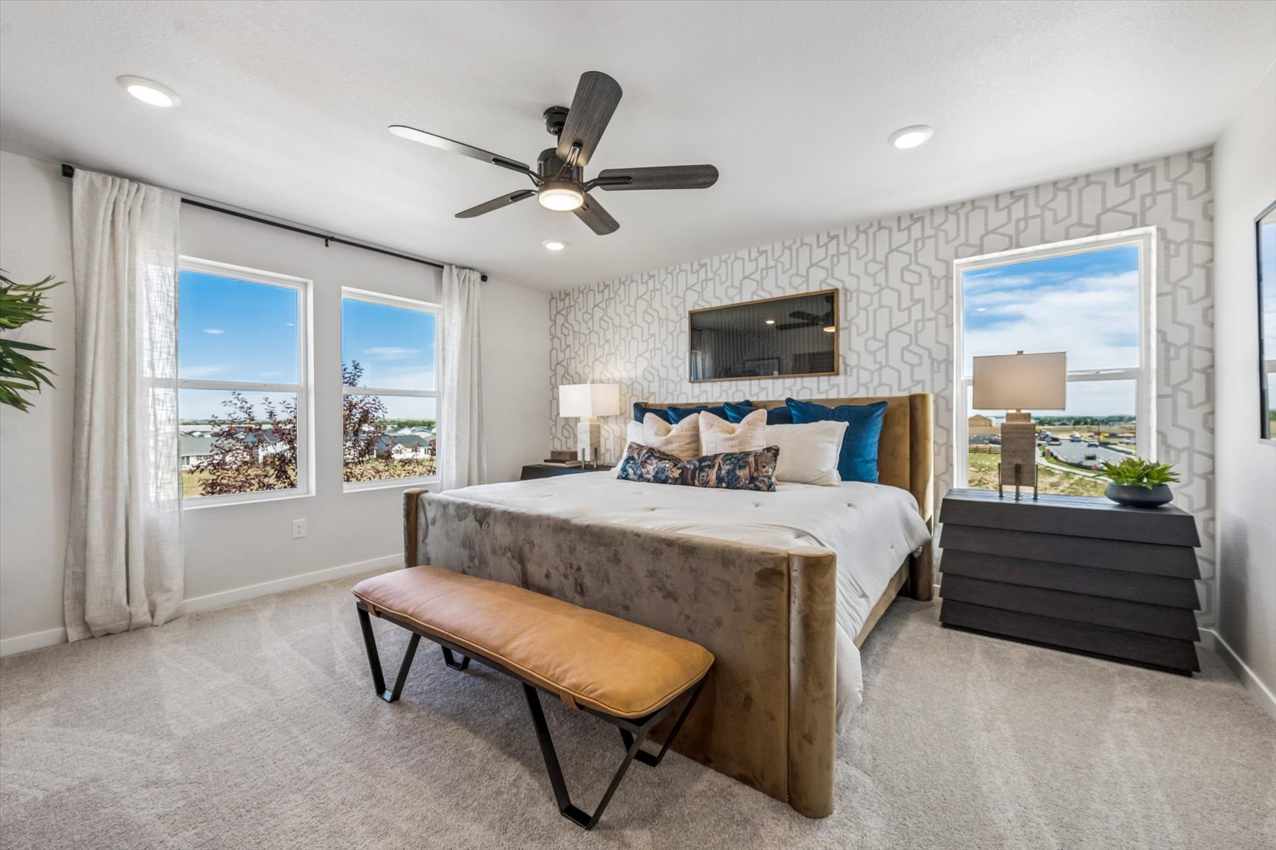 A bedroom with a bed and a table.