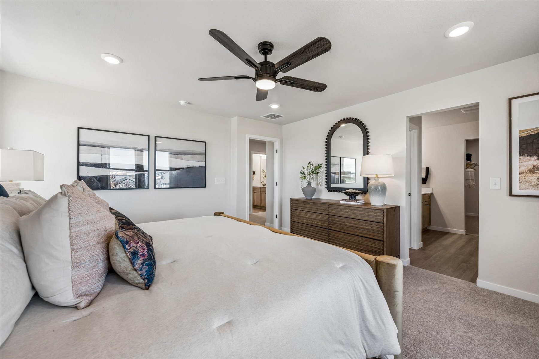 A bedroom with a bed and a fan.
