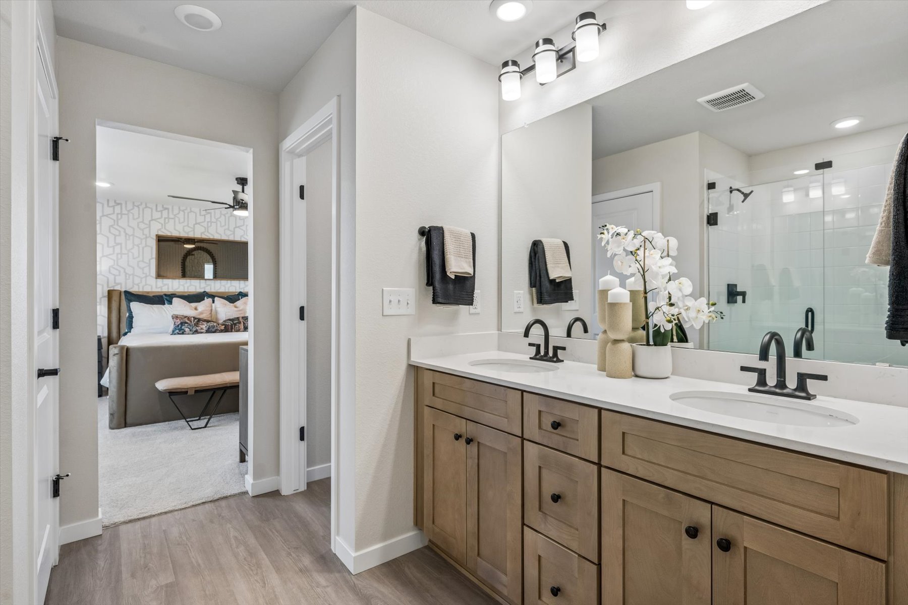 A bathroom with a large mirror.