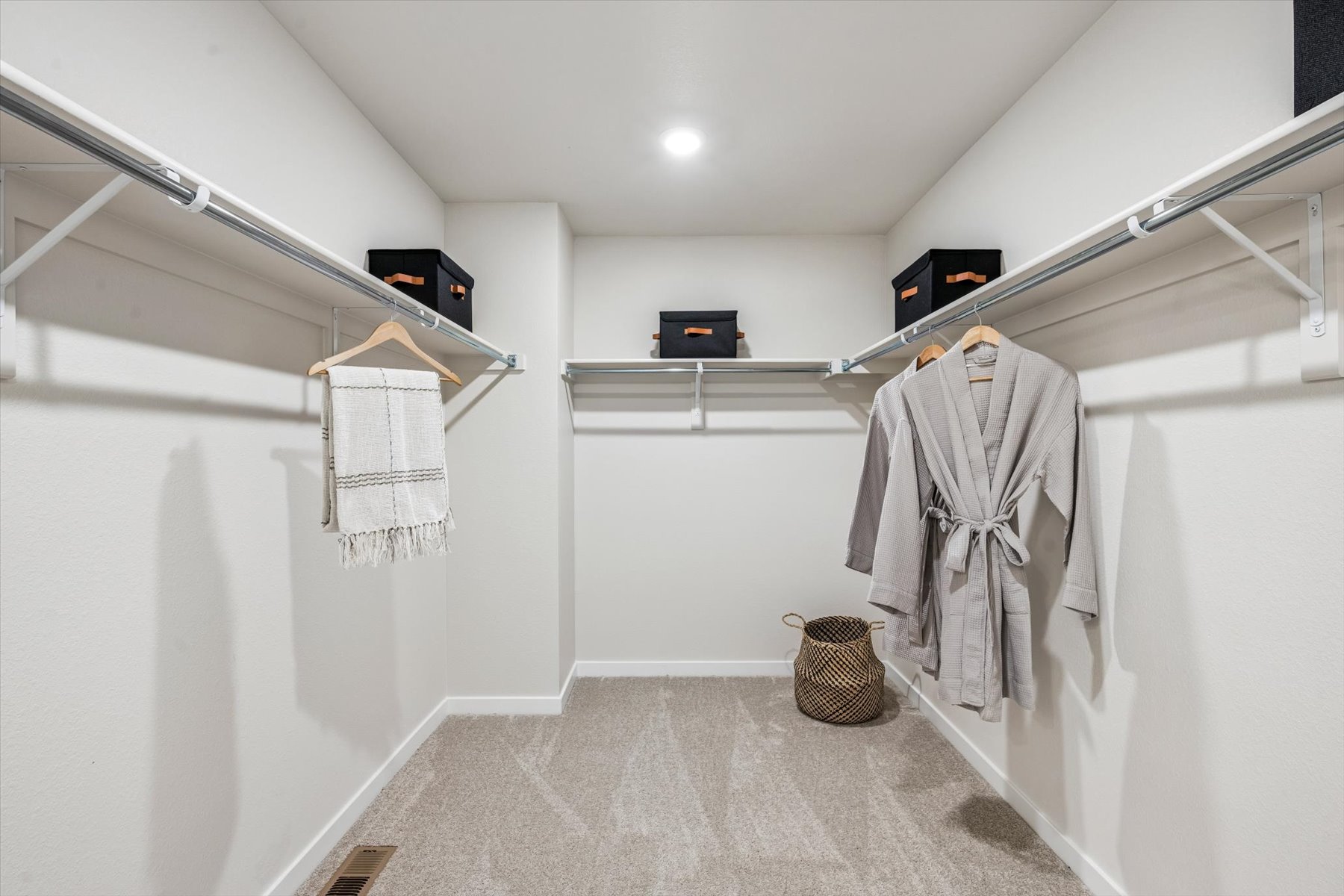 A white room with a white wall and a basket with clothes.