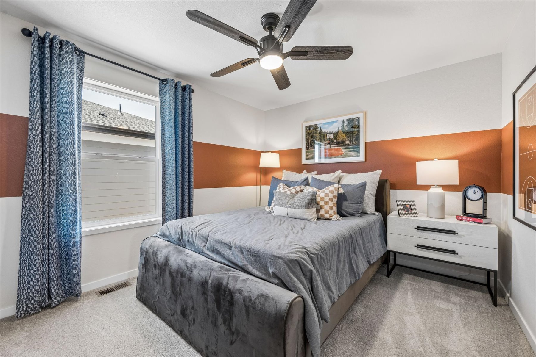 A bedroom with a bed and a fan.