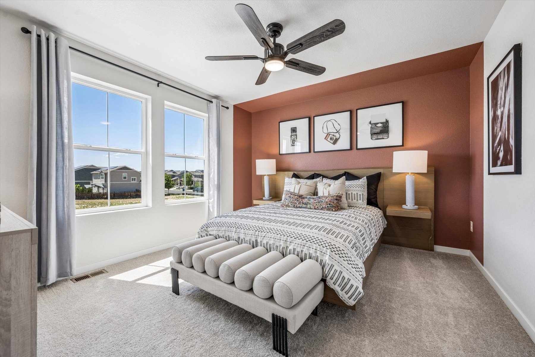 A bedroom with a large window.