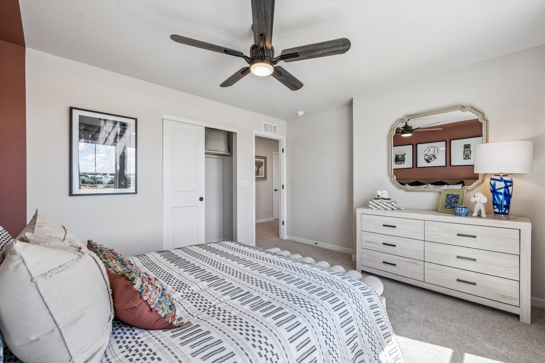 A bedroom with a bed and a fan.