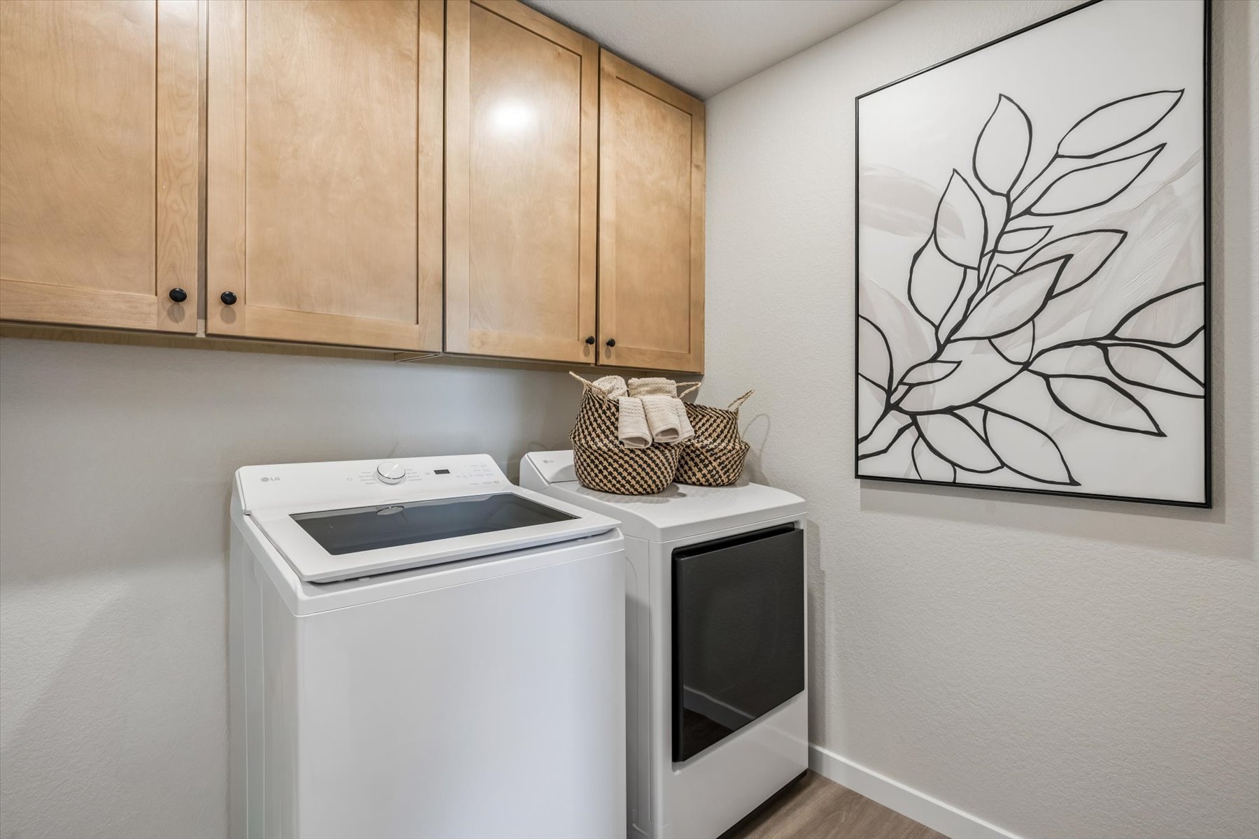 A kitchen with a drawing on the wall.